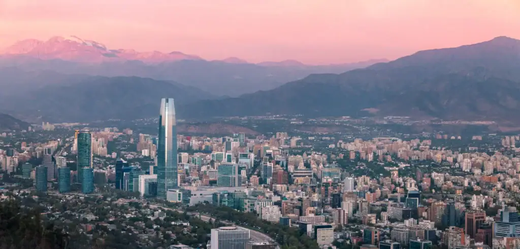 Snow-capped mountains in Chilean santiago with a pink sky – Chile offers excellent safety and reliable transport