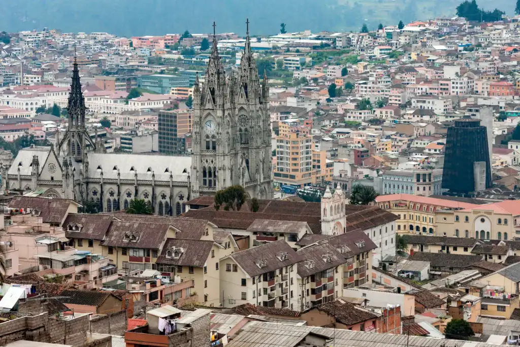 Scenic aerial view of Quito, Ecuador, featuring the Basilica of the National Vow surrounded by colorful city buildings—highlighting one of the safest and most beautiful places to visit in South America.