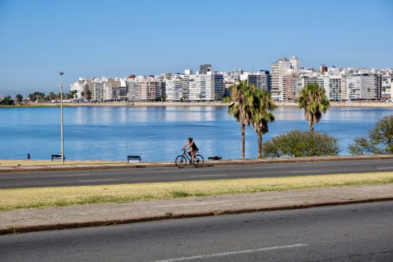 woman biking along the coast of monetevideo urugua