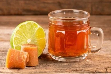 Traditional Colombian aguapanela drink in a clay cup