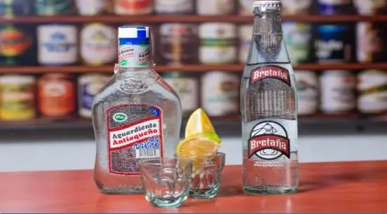 Colombian aguardiente bottle with shot glasses