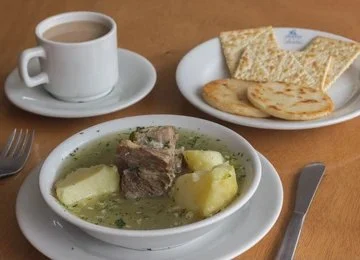Traditional Colombian caldo de costilla beef rib soup with potatoes and scallions