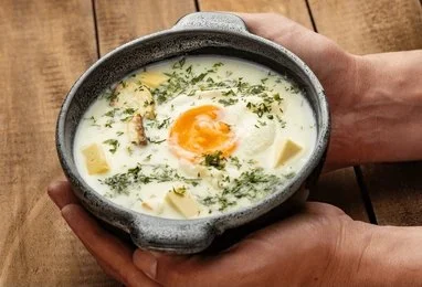 Traditional Colombian changua breakfast soup with milk, eggs, and scallions