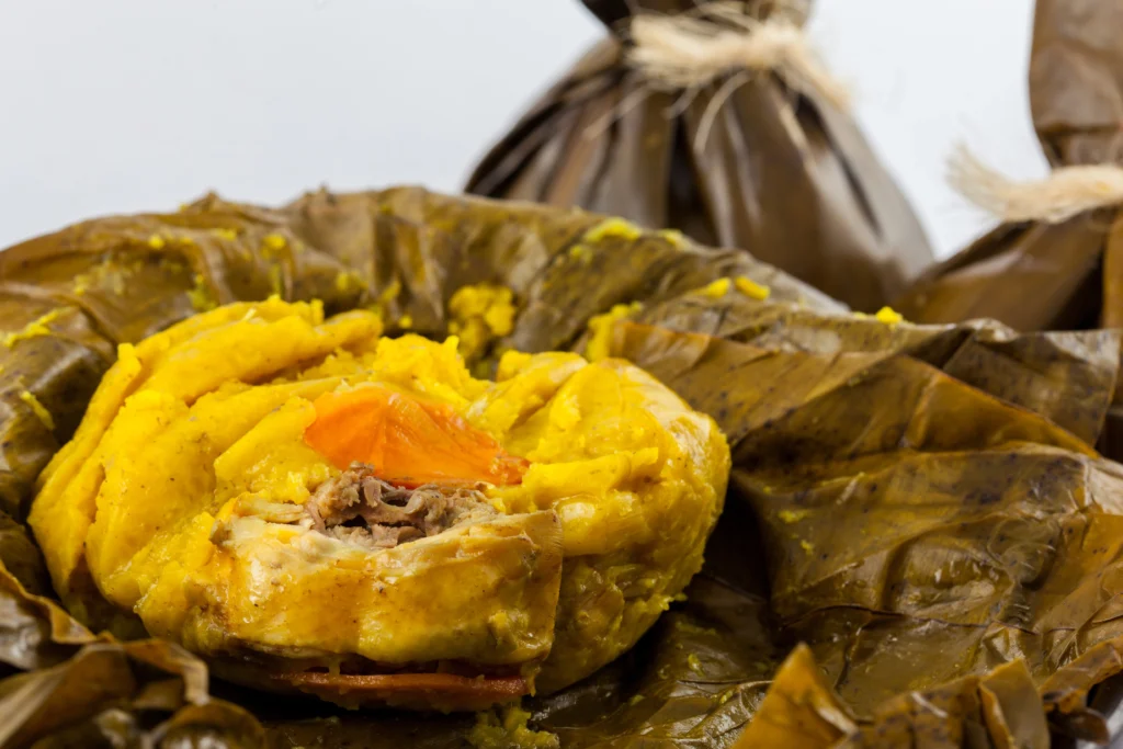 Traditional Colombian Tamales Tolimenses wrapped in banana leaves
