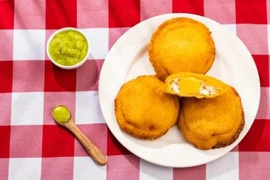 Arepas, traditional Colombian corn cakes served grilled with cheese or egg